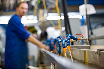 Machine Setter, Mark, guiding the profile along the extrusion line. 